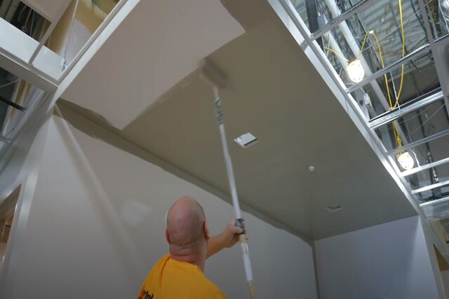 Sparks Painter commercial painting a ceiling with a roller