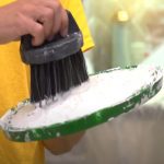 Worker mixing the paint with a paint brush